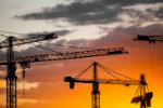 Construction cranes against the sky