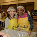 Two ladies volunteer at a food bank