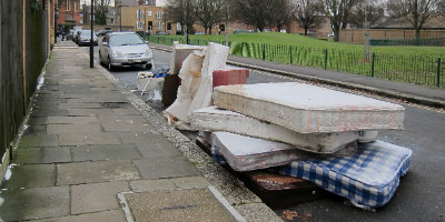 Mattresses piled as trash in the street