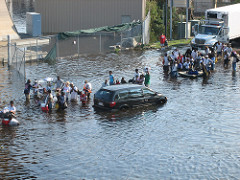 People lining up in heavily flooded water