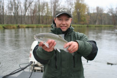 Fisherman proudly holding a caught steelhead